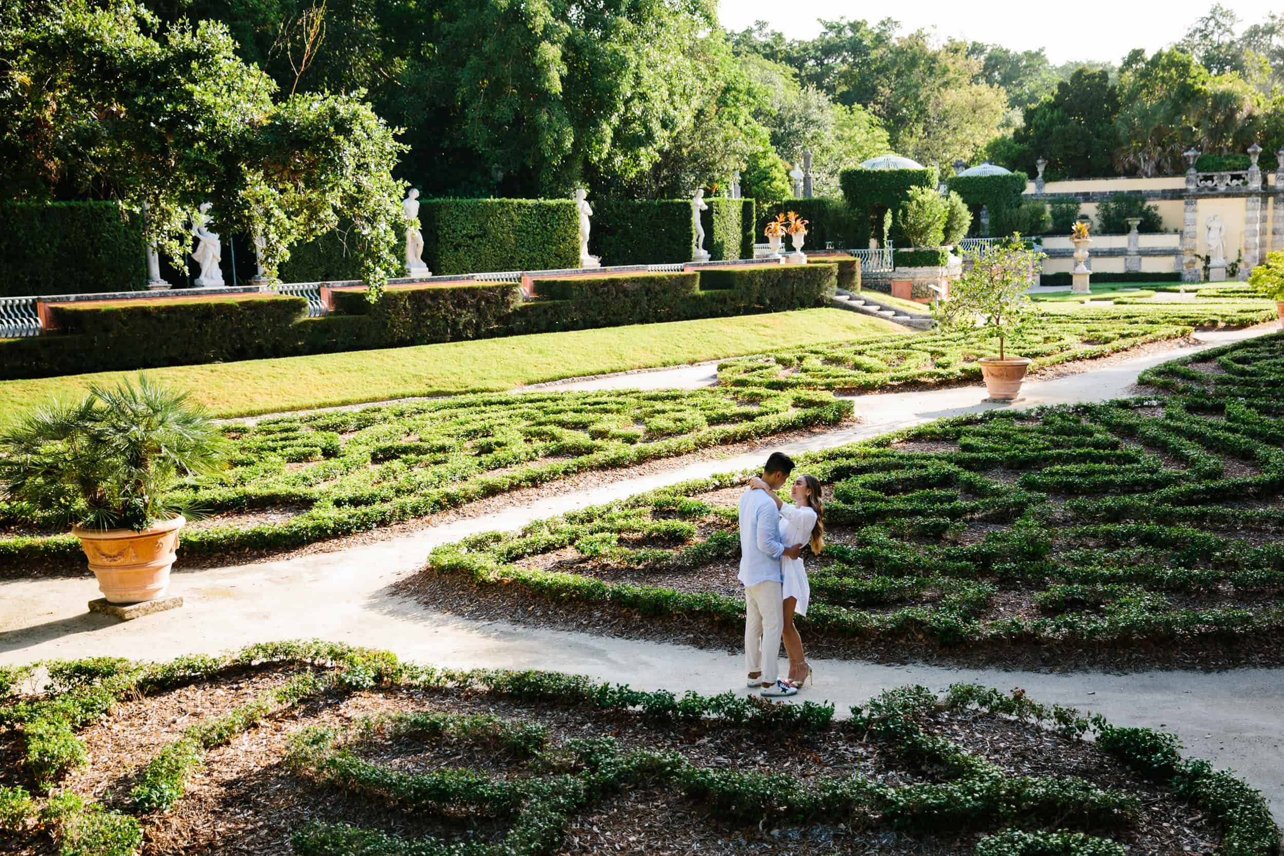 Couple hugging during their engagement session at Vizcaya 