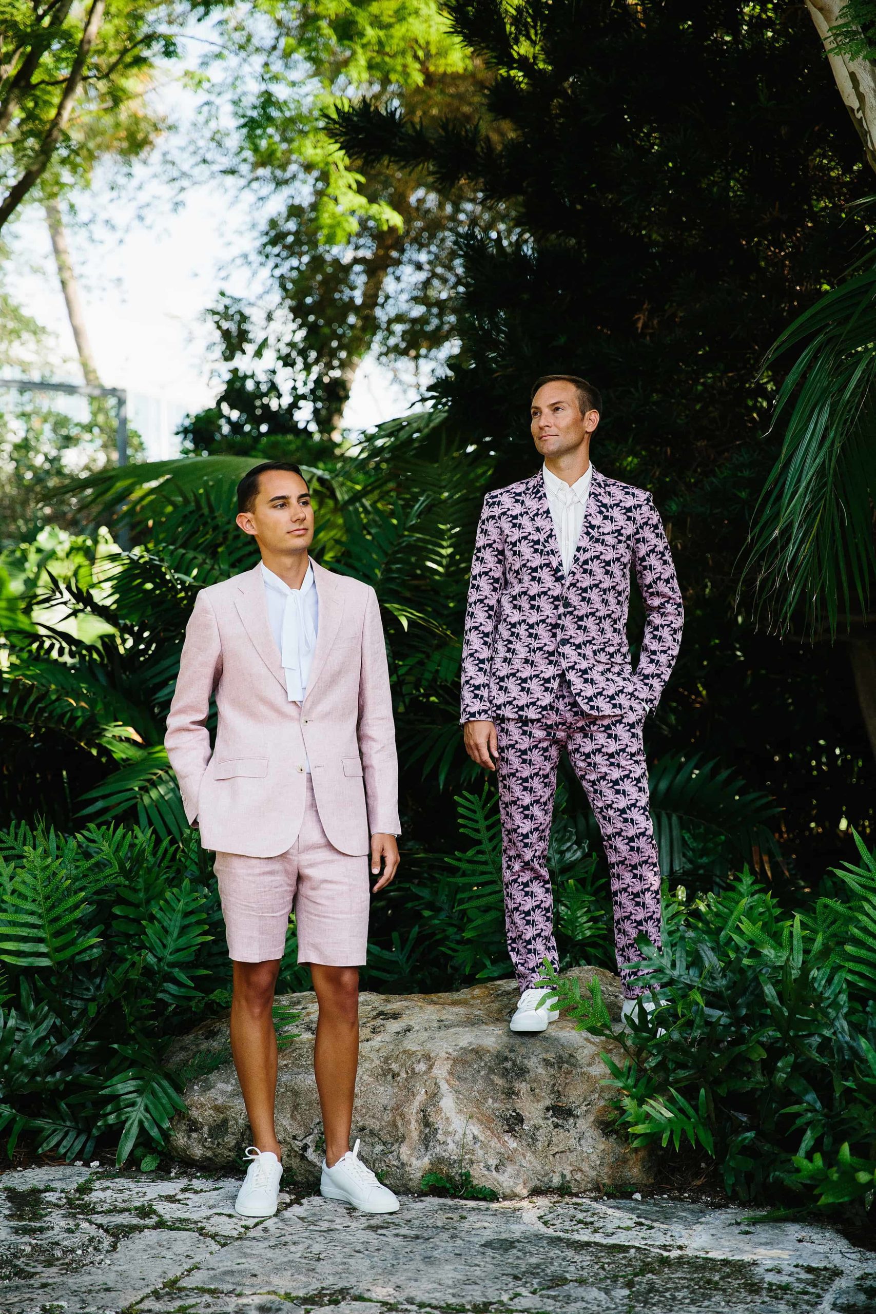 Grooms wearing a short suit and a bold print suit for their stylish wedding at the Miami Beach Botanical Garden 